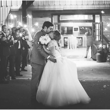 black and white photo bride and groom kiss